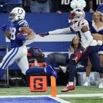
              Indianapolis Colts running back Jonathan Taylor (28) scores past New England Patriots cornerback J.C. Jackson (27) for a 67-yard touchdown during the second half of an NFL football game Saturday, Dec. 18, 2021, in Indianapolis. (AP Photo/AJ Mast)
            