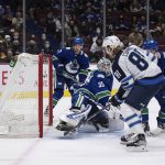 
              Winnipeg Jets' Kyle Connor (81) scores against Vancouver Canucks goalie Thatcher Demko (35) during the second period of an NHL hockey game Friday, Dec. 10, 2021, in Vancouver, British Columbia. (Darryl Dyck/The Canadian Press via AP)
            