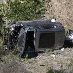 
              FILE - A vehicle rests on its side after a rollover accident involving golfer Tiger Woods along a road in the Rancho Palos Verdes suburb of Los Angeles on Tuesday, Feb. 23, 2021. Ten months after he shattered bones in his right leg from a car crash in Los Angeles, Tiger Woods is playing with 12-year-old son Charlie in the tournament that pairs parents and children. (AP Photo/Ringo H.W. Chiu, File)
            