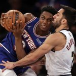 
              New York Knicks guard RJ Barrett (9) drives into Denver Nuggets guard Facundo Campazzo during the first half of an NBA basketball game Saturday, Dec. 4, 2021, in New York. (AP Photo/Adam Hunger)
            