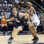 
              Utah State forward Justin Bean (34) drives as BYU forward Seneca Knight, right, defends in the first half during an NCAA college basketball game Wednesday, Dec. 8, 2021, in Provo, Utah. (AP Photo/Rick Bowmer)
            