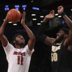 
              North Carolina State's Jaylon Gibson (11) shoots against Purdue's Trevion Williams (50) during the first half of an NCAA college basketball game Sunday, Dec. 12, 2021, in New York. (AP Photo/Jason DeCrow)
            