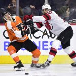 
              Philadelphia Flyers' Travis Konecny, left, is checked off the puck by New Jersey Devils' Michael McLeod during the second period of an NHL hockey game, Tuesday, Dec. 14, 2021, in Philadelphia. (AP Photo/Derik Hamilton)
            