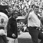 
              FILE - Oakland Raiders coach John Madden, right, does a sort of jig as he waves his finger and shouts in protest at a referee's call during the third quarter of the team's NFL football game against the Kansas City Chiefs on Dec. 12, 1970, in Oakland, Calif. Madden, the Hall of Fame coach turned broadcaster whose exuberant calls combined with simple explanations provided a weekly soundtrack to NFL games for three decades, died Tuesday morning, Dec. 28, 2021, the league said. He was 85. The NFL said he died unexpectedly and did not detail a cause. (AP Photo, File)
            