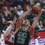 
              Boston Celtics center Enes Freedom, right, looks to shoot against Portland Trail Blazers center Cody Zeller, left, during the first half of an NBA basketball game in Portland, Ore., Saturday, Dec. 4, 2021. (AP Photo/Steve Dipaola)
            