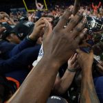 
              UTSA players reach to touch the championship trophy after an NCAA college football game in the Conference USA Championship against Western Kentucky, Friday, Dec. 3, 2021, in San Antonio. (AP Photo/Eric Gay)
            