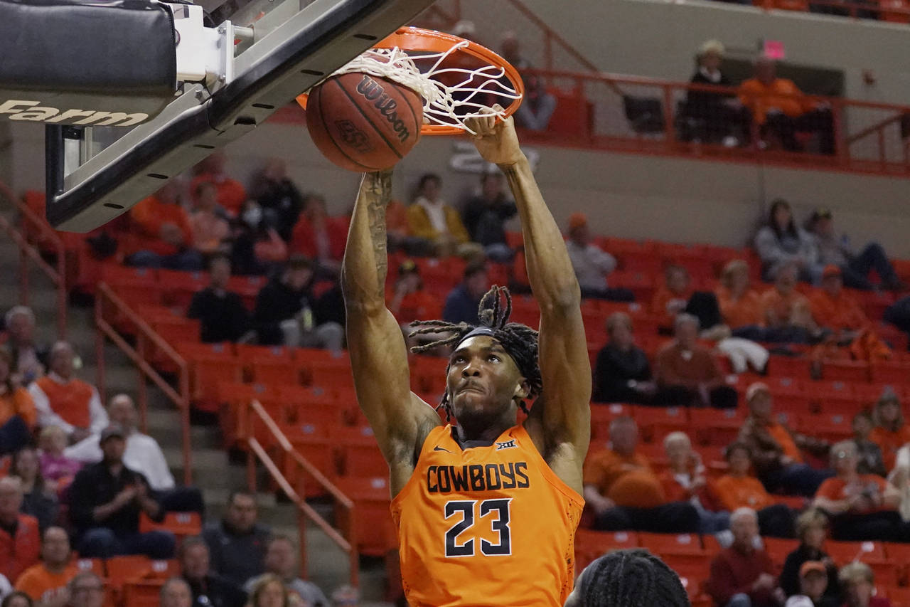 Oklahoma State forward Tyreek Smith (23) dunks in the first half of an NCAA college basketball game...