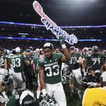 
              Michigan State players celebrate a win after the Peach Bowl NCAA college football game between Pittsburgh and Michigan State, Thursday, Dec. 30, 2021, in Atlanta. Michigan State won 31-21. (AP Photo/John Bazemore)
            