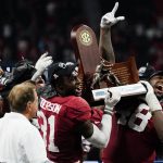 
              Alabama linebacker Will Anderson Jr. (31) and Alabama defensive lineman Phidarian Mathis (48) hold the Championship trophey after the Southeastern Conference championship NCAA college football game between Georgia and Alabama, Saturday, Dec. 4, 2021, in Atlanta. Alabama won 41-24. (AP Photo/John Bazemore)
            