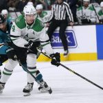 
              Dallas Stars defenseman Miro Heiskanen (4) reaches for the puck in front of San Jose Sharks center Andrew Cogliano (11) during the first period of an NHL hockey game in San Jose, Calif., Saturday, Dec. 11, 2021. (AP Photo/Jeff Chiu)
            