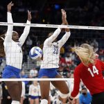 
              Pittsburgh's Chinaza Ndee, left, and Chiamaka Nwokolo block a shot by Nebraska's Ally Batenhorst during a semifinal of the NCAA women's college volleyball tournament Friday, Dec. 17, 2021, in Columbus, Ohio. (AP Photo/Paul Vernon)
            