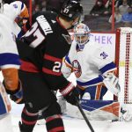 
              New York Islanders goaltender Ilya Sorokin (30) uses his pad to keep the puck out of his net as Ottawa Senators centre Dylan Gambrell (27) looks on during the second period of an NHL hockey game Tuesday, Dec. 7, 2021, in Ottawa, Ontario. (Justin Tang/The Canadian Press via AP)
            