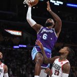 
              Los Angeles Lakers forward LeBron James (6) shoots over Portland Trail Blazers guard Ben McLemore (23) during the first half of an NBA basketball game Friday Dec. 31, 2021, in Los Angeles. (AP Photo/John McCoy)
            
