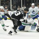 
              Los Angeles Kings' Viktor Arvidsson, center, chases the puck deflected by Vancouver Canucks goaltender Jaroslav Halak during second period of an NHL hockey game Thursday, Dec. 30, 2021, in Los Angeles. (AP Photo/Jae C. Hong)
            