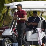 
              Tiger Woods watches his shot during a training session at the Albany Golf Club, in New Providence, Bahamas, Sunday, Dec. 5, 2021.(AP Photo/Fernando Llano)
            