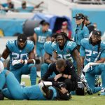 
              Jacksonville Jaguars players take a knee after free safety Rayshawn Jenkins, front, was injured on a play against the Houston Texans during the first half of an NFL football game, Sunday, Dec. 19, 2021, in Jacksonville, Fla. (AP Photo/Stephen B. Morton)
            