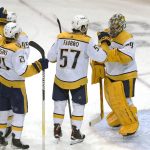 
              Nashville Predators goaltender Juuse Saros (74) is congratulated by teammates after defeating the New York Rangers 1-0 in an NHL hockey game, Sunday, Dec. 12, 2021, in New York. The Nashville Predators won 1-0. (AP Photo/Noah K. Murray)
            