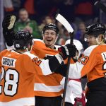 
              Philadelphia Flyers' Justin Braun, center, celebrates his goal with Claude Giroux, left, and Oskar Lindblom during the second period of an NHL hockey game against the New Jersey Devils, Tuesday, Dec. 14, 2021, in Philadelphia. (AP Photo/Derik Hamilton)
            