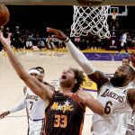 
              Orlando Magic center Robin Lopez (33) shoots under pressure from Los Angeles Lakers forward LeBron James (6) during the first half of an NBA basketball game in Los Angeles, Sunday, Dec. 12, 2021. (AP Photo/Ringo H.W. Chiu)
            