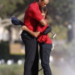 
              Tiger Woods hugs son Charlie Woods on the 18th green after the second round of the PNC Championship golf tournament, Sunday, Dec. 19, 2021, in Orlando, Fla. (AP Photo/Scott Audette)
            