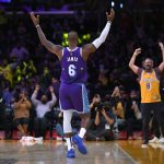 
              Los Angeles Lakers forward LeBron James (6) motions to the crowd during the first half of the team's NBA basketball game against the Portland Trail Blazers, Friday Dec. 31, 2021, in Los Angeles. (AP Photo/John McCoy)
            