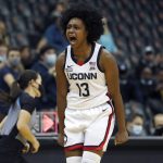 
              Connecticut guard Christyn Williams (13) reacts after making a 3-point shot against UCLA during the second half of an NCAA college basketball game in Newark, N.J., Saturday, Dec. 11, 2021. Connecticut won 71-61. (AP Photo/Noah K. Murray)
            