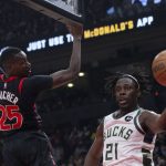 
              Milwaukee Bucks' Jrue Holiday passes the ball as Toronto Raptors' Chris Boucher defends during the first half of an NBA basketball game Thursday, Dec. 2, 2021, in Toronto. (Chris Young/The Canadian Press via AP)
            