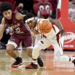 
              Arkansas guard Chris Lykes (11) steals the ball from Arkansas-Little Rock guard D.J. Smith (13) during the first half of an NCAA college basketball game Saturday, Dec. 4, 2021, in Fayetteville, Ark. (AP Photo/Michael Woods)
            