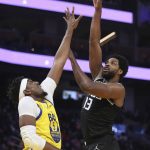 
              Sacramento Kings forward Tristian Thompson (13) shoots against Golden State Warriors forward Kevon Looney (5) during the first half of an NBA basketball game in San Francisco, Monday, Dec. 20, 2021. (AP Photo/Jed Jacobsohn)
            