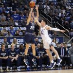 
              Utah State guard Brock Miller (22) shoots as BYU guard Alex Barcello (13) defends in the first half during an NCAA college basketball game Wednesday, Dec. 8, 2021, in Provo, Utah. (AP Photo/Rick Bowmer)
            