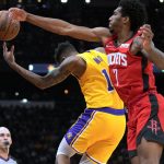 
              Houston Rockets guard Armoni Brooks (7) and Los Angeles Lakers guard Malik Monk chase the ball during the first half of an NBA basketball game Tuesday, Dec. 28, 2021, in Houston. (AP Photo/Eric Christian Smith)
            