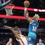 
              Charlotte Hornets guard Kelly Oubre Jr. (12) shoots over Houston Rockets guard Armoni Brooks (7) during the first half of an NBA basketball game Monday, Dec. 27, 2021, in Charlotte, N.C. (AP Photo/Matt Kelley)
            