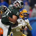 
              Michigan State tight end Connor Heyward (11) makes a touchdown catch against Pittsburgh defensive back Brandon Hill (9) during the second half of the Peach Bowl NCAA college football game, Thursday, Dec. 30, 2021, in Atlanta. (AP Photo/John Bazemore)
            