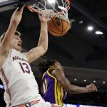 
              Auburn forward Walker Kessler (13) slam dunks the ball over LSU guard Justice Williams (11) during the second half of an NCAA college basketball game Wednesday, Dec. 29, 2021, in Auburn, Ala. (AP Photo/Butch Dill)
            