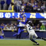 
              Los Angeles Rams wide receiver Cooper Kupp, top, catches a pass over Seattle Seahawks cornerback Sidney Jones during the second half of an NFL football game Tuesday, Dec. 21, 2021, in Inglewood, Calif. (AP Photo/Ashley Landis )
            