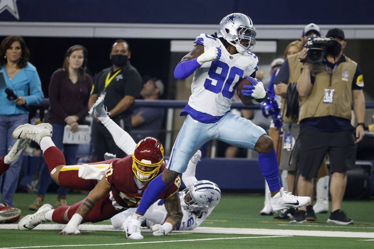Dallas Cowboys defensive end Demarcus Lawrence (90) breaks tackles on the way to the end zone for a...