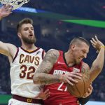 
              Houston Rockets' Daniel Theis (27) grabs a rebound ahead of Cleveland Cavaliers' Dean Wade (32) in the first half of an NBA basketball game, Wednesday, Dec. 15, 2021, in Cleveland. (AP Photo/Tony Dejak)
            