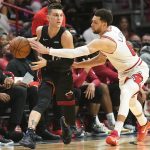 
              Miami Heat guard Tyler Herro (14) looks to pass the ball as Chicago Bulls guard Zach LaVine (8) defends during the second half of an NBA basketball game, Saturday, Dec. 11, 2021, in Miami. (AP Photo/Marta Lavandier)
            