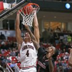
              Texas Tech's Daniel Batcho (4) dunks the ball over Arkansas State's Markise Davis (1) during the first half of an NCAA college basketball game on Tuesday, Dec. 14, 2021, in Lubbock, Texas. (AP Photo/Brad Tollefson)
            