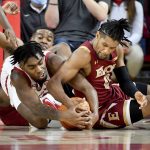 
              Arkansas forward Kamani Johnson (20) and Elon guard Hunter McIntosh (0) fight for control of the ball during the second half of an NCAA college basketball game Tuesday, Dec. 21, 2021, in Fayetteville, Ark. (AP Photo/Michael Woods)
            