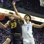 
              Missouri's Trevon Brazile (23) pulls down a rebound next to Kentucky's Jacob Toppin (0) during the first half of an NCAA college basketball game in Lexington, Ky., Wednesday, Dec. 29, 2021. (AP Photo/James Crisp)
            
