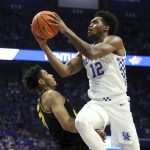
              Kentucky's Keion Brooks Jr. (12) shoots over Missouri's Ronnie DeGray III (21) during the first half of an NCAA college basketball game in Lexington, Ky., Wednesday, Dec. 29, 2021. (AP Photo/James Crisp)
            