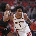 
              Texas Tech's Terrence Shannon, Jr. (1) dribbles the ball around Arkansas State's Marquis Eaton (23) during the first half of an NCAA college basketball game on Tuesday, Dec. 14, 2021, in Lubbock, Texas. (AP Photo/Brad Tollefson)
            
