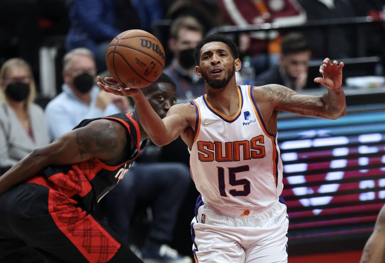 Phoenix Suns guard Cameron Payne, right, loses control of the ball as Portland Trail Blazers forwar...