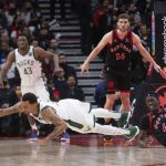 
              Milwaukee Bucks guard George Hill dives to claim a loose ball next to Toronto Raptors' Pascal Siakam (43) during the second half of an NBA basketball game Thursday, Dec. 2, 2021, in Toronto. (Chris Young/The Canadian Press via AP)
            