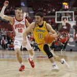 
              Towson's Antonio Rizzuto, right, dribbles past Ohio State's Justin Ahrens during the first half of an NCAA college basketball game Wednesday, Dec. 8, 2021, in Columbus, Ohio. (AP Photo/Jay LaPrete)
            