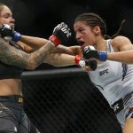 
              Julianna Pena, right, hits Amanda Nunes during a women's bantamweight mixed martial arts title bout at UFC 269, Saturday, Dec. 11, 2021, in Las Vegas. (AP Photo/Chase Stevens)
            