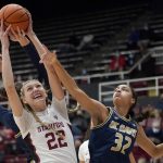 
              Stanford forward Cameron Brink (22) grabs a rebound over UC Davis forward Cierra Hall (32) during the first half of an NCAA college basketball game in Stanford, Calif., Wednesday, Dec. 15, 2021. (AP Photo/Jeff Chiu)
            