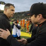
              Oregon head coach Mario Cristobal, left, and Oregon State head coach Jonathan Smith shake hands after an NCAA college football game Saturday, Nov. 27, 2021, in Eugene, Ore. (AP Photo/Andy Nelson)
            