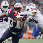 
              New England Patriots running back Damien Harris (37) hangs onto the ball as Buffalo Bills free safety Jordan Poyer, right, tries for the strip on his touchdown run during the first half of an NFL football game, Sunday, Dec. 26, 2021, in Foxborough, Mass. (AP Photo/Winslow Townson)
            